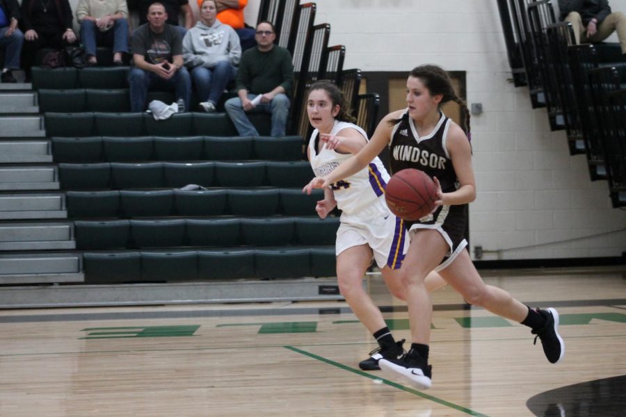 Madi Miller drives down the court.