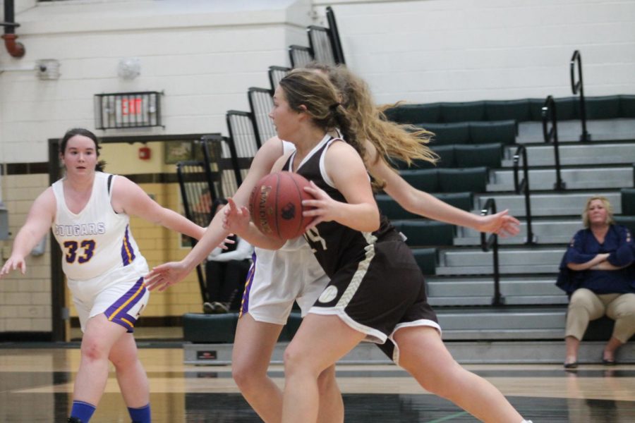 Piper Montgomery drives to the basket.