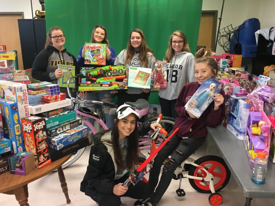 (From top left) Emily Krummrich, Taylor Turner, Kristina Johnson, Abby Roth, (from bottom left) Gaby Dorris and Morgan Cancienne all helped with the 2017 DECA Toy Drive. 