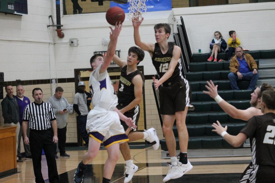 Derek Williams and Evan Worley block an opponent's layup.