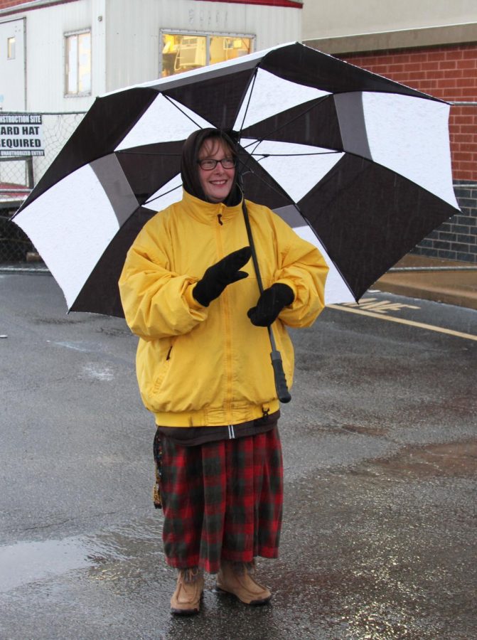 Teacher at Windsor High School, Mrs. Miller, stands out in the snow with a warm, welcoming smile.