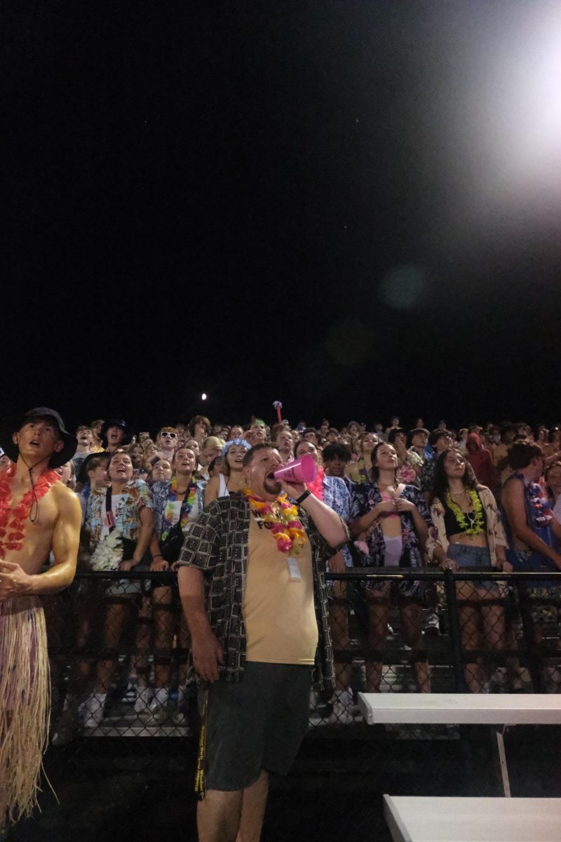 Assistant Principal Alex DeMatteis leads chants with the Owl Crowd on Friday. 